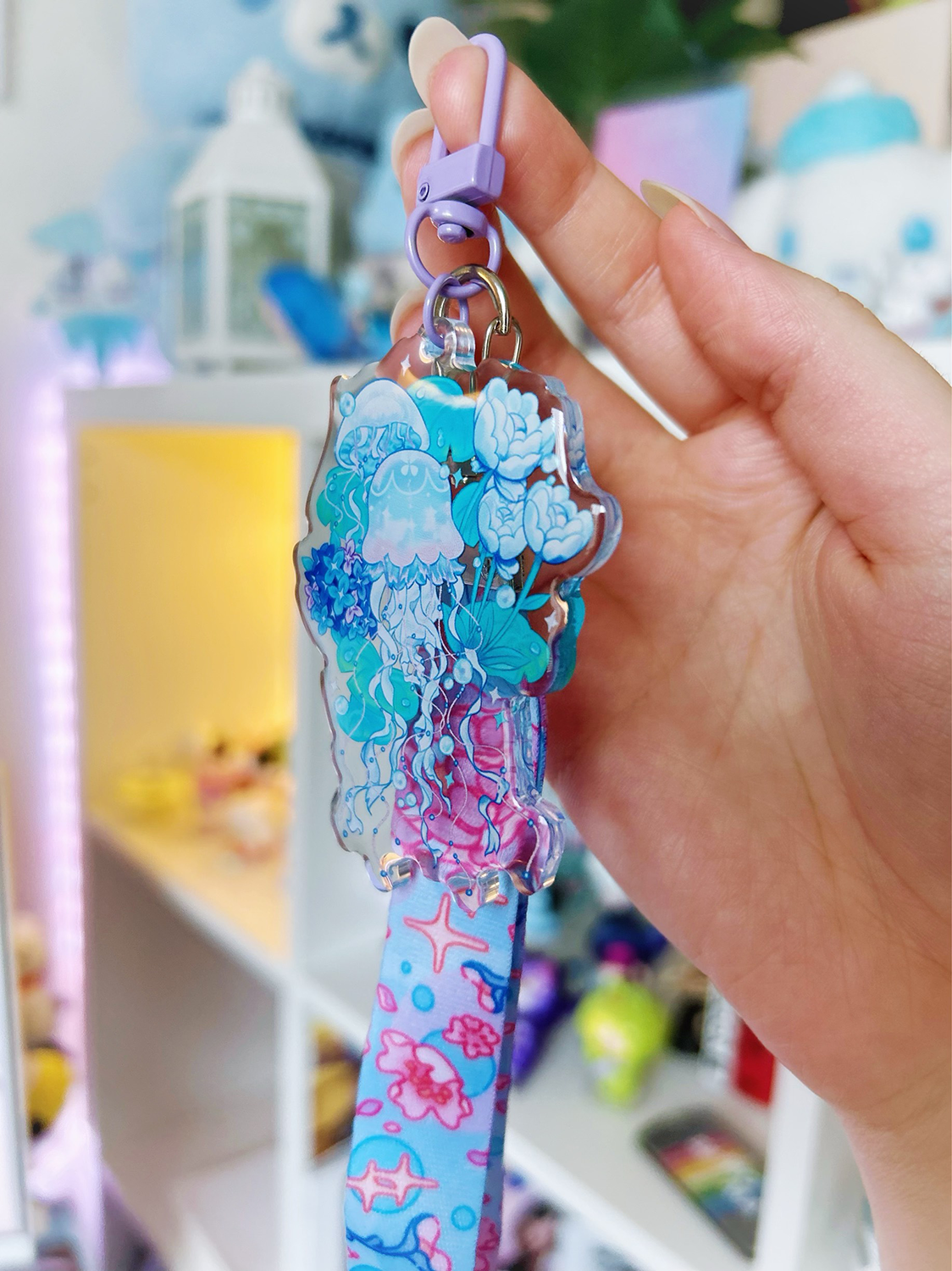 An acrylic lanyard keychain featuring a Jellyfish Garden concept