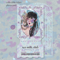 A collectible ticket photocard featuring an oval portrait of a hand painted, fantasy inspired illustration. The artwork features a girl with lavender purple flowers and a baby blue ribbon in her hair.
