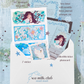 Collection of swan themed stationery featuring an art print postcard, sticker, photocard, and letter in a snail mail club envelope.